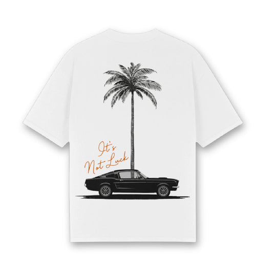 White t-shirt with a black car and palm tree graphic and text on a white background